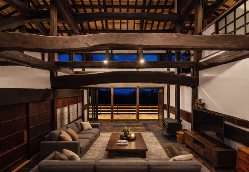 Authentic Japanese Kominka interior featuring massive hand-hewn pine beams and traditional timber frame